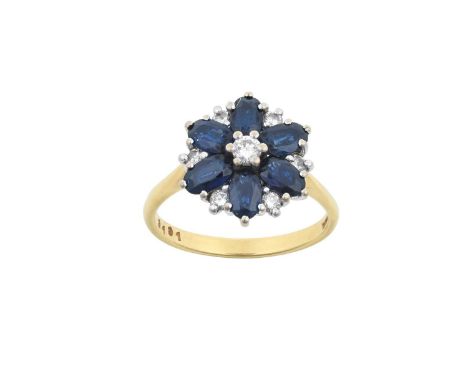 An 18 Carat Gold Sapphire and Diamond Cluster Ringthe central raised round brilliant cut diamond within a border of oval cut 