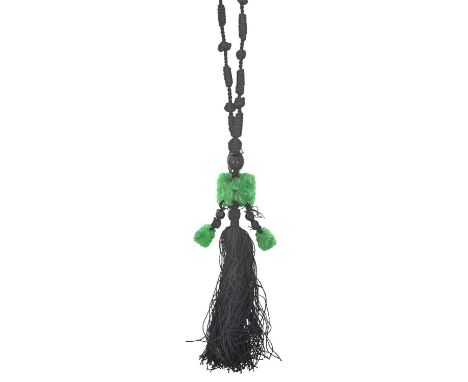 A Jade and Onyx Tassel Necklacean onyx bead suspends a rectangular carved and pierced jade plaque, with two similar smaller d