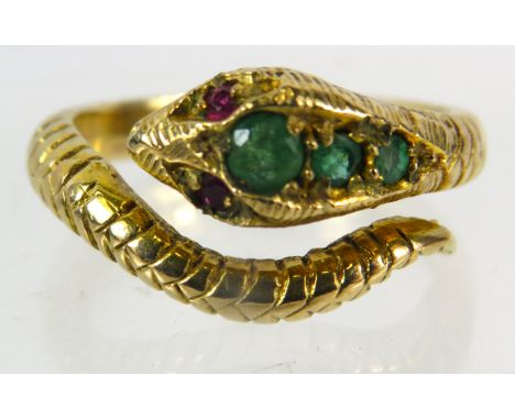 9ct gold Snake ring with ruby eyes and 3 emeralds set to the head, finger size O.5. 5.2grams.