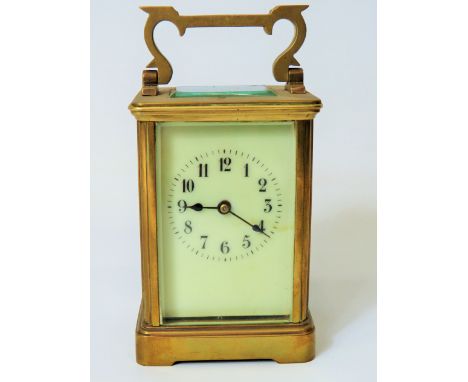 Brass Carriage Clock with enamel face. Glass panels and door.  Running order, requires key.  5 inches tall. See photos. 