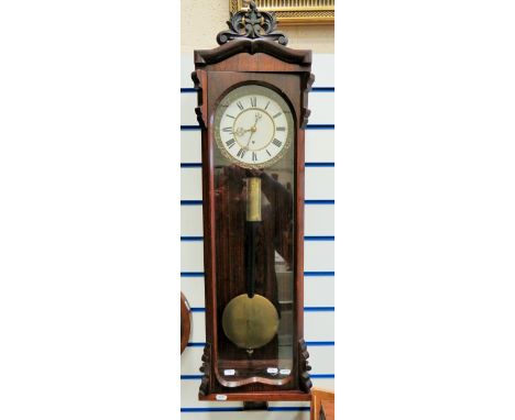 Mahogany cased wall clock with enamel dial. Single weight drive. Running order with key.  Approx 42 inches long. See photos. 