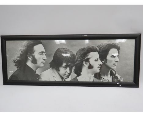 Framed Print of the Beatles which measures 39 x 14 inches. See photo