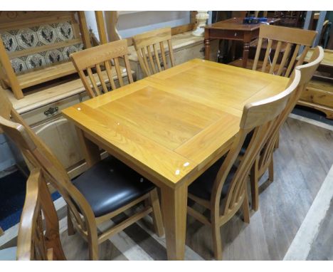 Modern Light Oak Table with two extender leaves. Comes with Four matching chairs with leatherette seats, shaped back rests an