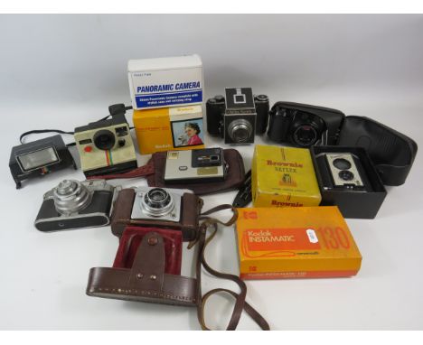 Large selection of various vintage cameras.