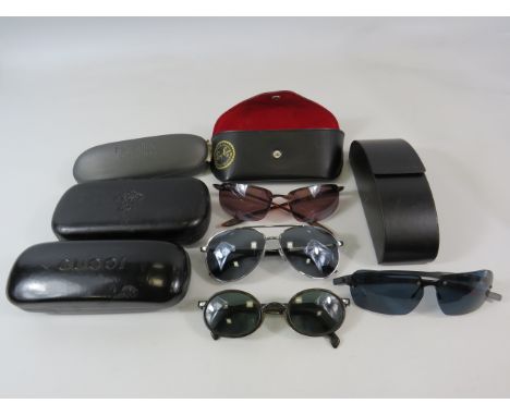 Various Sunglasses Prada, Ray-ban, Storm and Armani plus a few empty cases.