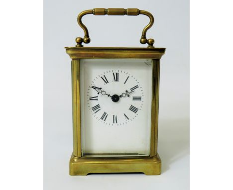 Brass Carriage Clock with enamel face. Glass panels and door. Makers or Retailers mark of ACC  Running order, requires key.  