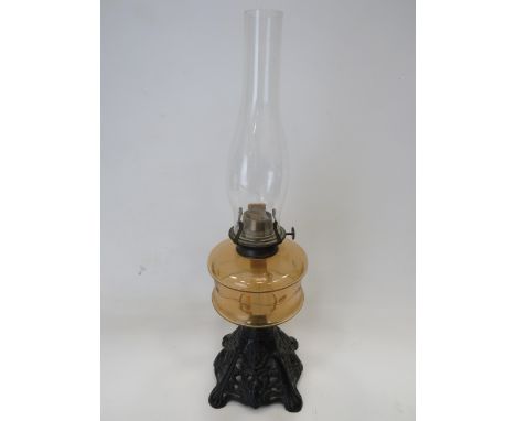 Pretty Metal and glass Oil Lamp with Pierced metal base and Unranium glass reservoir with clear glass shade. Measures approx 