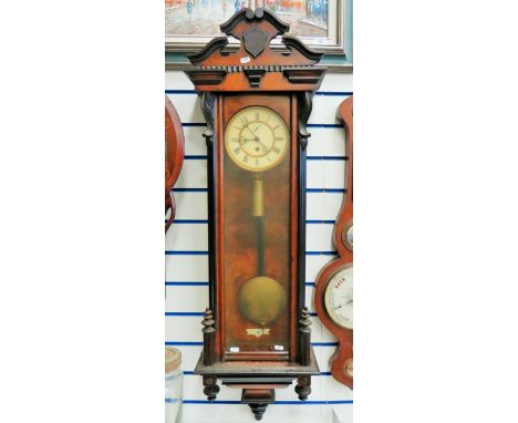 Large Mahogany Cased wall clock with enamel face, single weight driven with pendulum.  Approx 48 inches long. With key. Inter