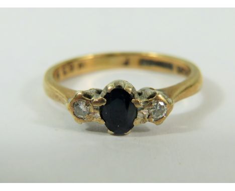 9ct Yellow Gold ring set with a Central Sapphire and flanked by two Melee Diamonds.  Finger size 'J'   2.0g