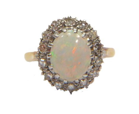 Stunning Opal Set ring with 14 Diamond surround set on an 18ct Yellow Gold shank. Opal Measures 10 x 6 mm. Diamond Weight app