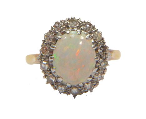 Stunning Opal Set ring with 14 Diamond surround set on an 18ct Yellow Gold shank. Opal Measures 10 x 6 mm. Diamond Weight app