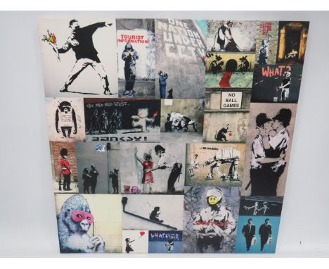 Framed print on a stretched Canvas of Banksy Art which measures 30 x 30 inches. See photos.