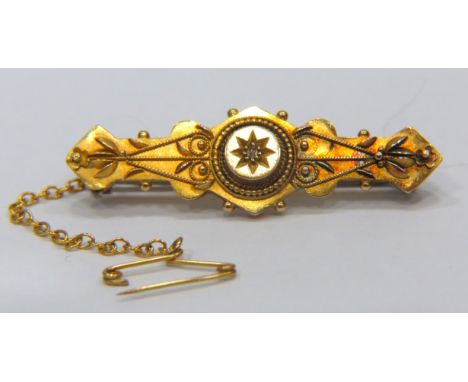 15ct Yellow Gold Antique brooch set with a central small Diamond.  Measures 3.1g  40mm long. Metal pin, Safety chain fitted. 