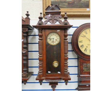 Oak Cased Wall Clock with enamel dial in working order.  38 inches long. See photos. 