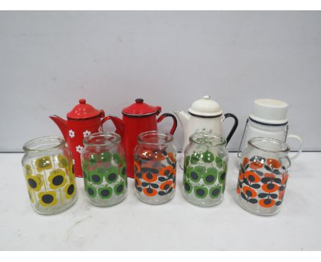 Selection of enamel teapots and retro style storage jars.