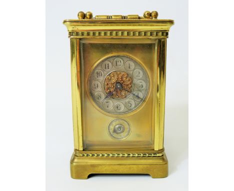 Brass Carriage clock with alarm,  glass panels and door. Enamel dial. Working order.   Requires key.  4.5 inches tall.  