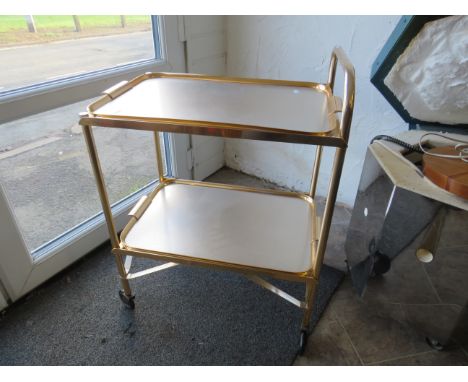 Gold metal retro tray trolley with two detachable trays.