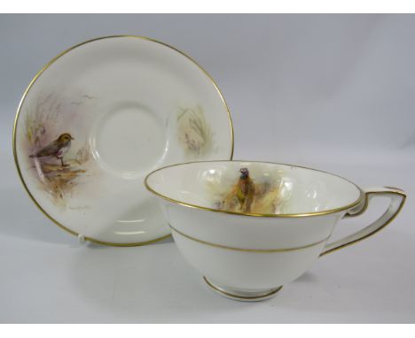 1949 Royal Worcester J Stinton cup and saucer, the cup painted with a pheasent and the saucer a Plover.