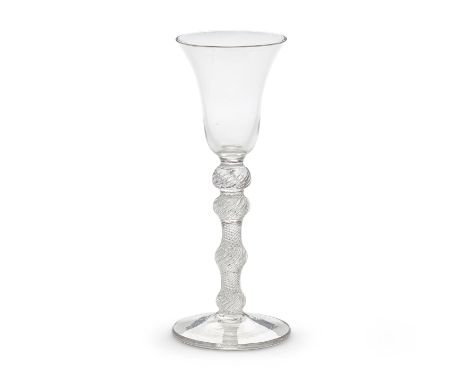 A rare four-knopped airtwist wine glass, circa 1750The bell bowl on a multi-spiral airtwist stem with two upper knops above l