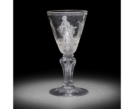 A fine Potsdam engraved moulded-stem large wine glass or goblet, circa 1730-50The round funnel bowl finely decorated with a c
