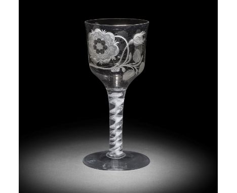 A rare Jacobite engraved opaque twist goblet, circa 1765The generous ogee bowl decorated with a large seven-petalled heraldic