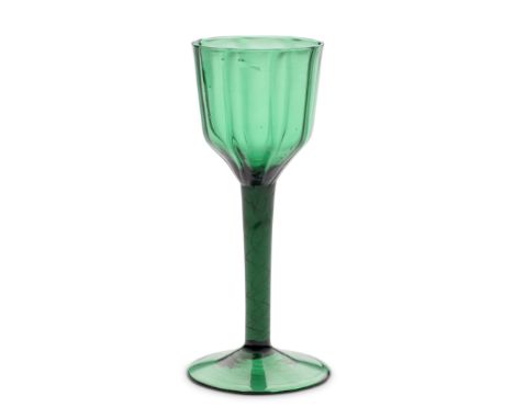 A fine emerald-green tinted airtwist goblet or large wine glass, circa 1750-60In deep green glass, the generous rib-moulded o