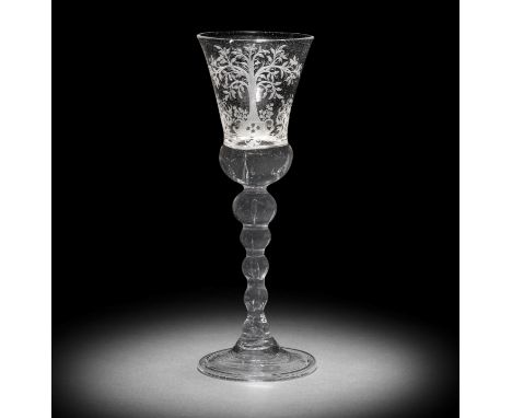 A Dutch engraved baluster 'Orangist' wine glass, mid-18th centuryThe glass German, the thistle-shaped bowl with a solid beade