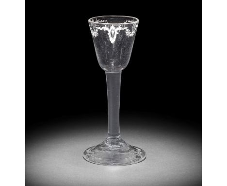 A very rare Beilby enamelled plain stem wine glass, circa 1765The round funnel bowl finely painted in opaque white with garla