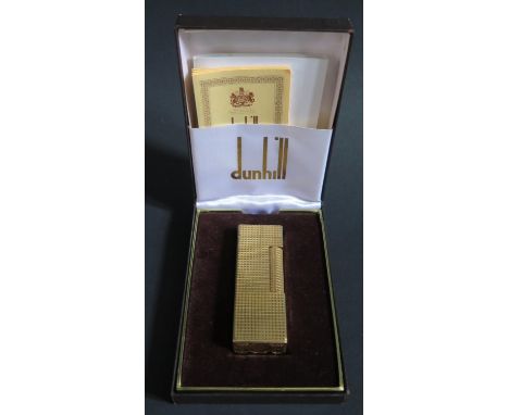 A Dunhill Gold Plated Lighter, cased and with guarantee papers, flint working, but out of gas 