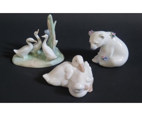 A Lladro Polar Bear and two Nao ornaments 