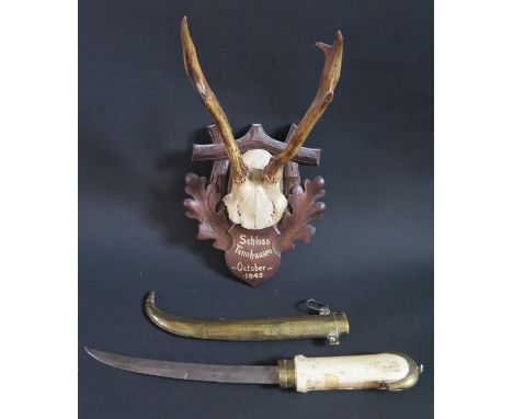 A Small Set of Mounted Horns on a carved back 'Schloss Tannhauseb October 1945' and a Middle Eastern dagger 