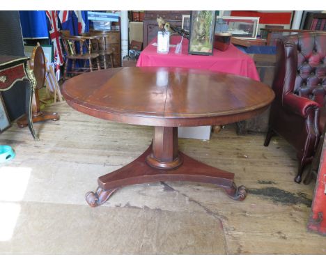 A Victorian Mahogany Tilt Top Circular Dining Table with a tripod base and scroll/lion claw feet. diameter 128cm