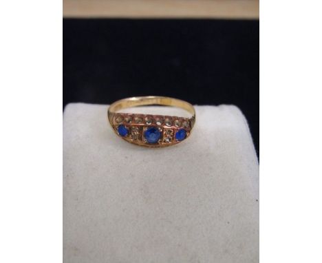 Gold ring stamped 18ct and Len with 3 blue stones 1.8gms size Q