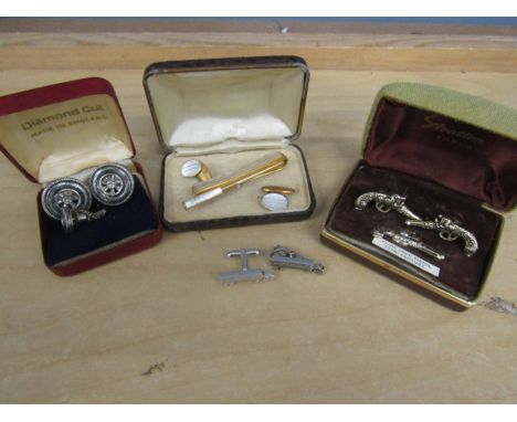 Flintlock rifle cufflinks and tie pin, a set of wheel ones, a m.o.p. set and 2 loose