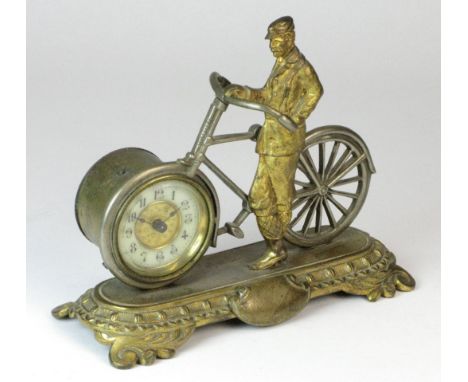 *Cycling Clock. An original desk clock depicting a cast-brass rider and his bicycle,  with a mechanical clock fitted to the f