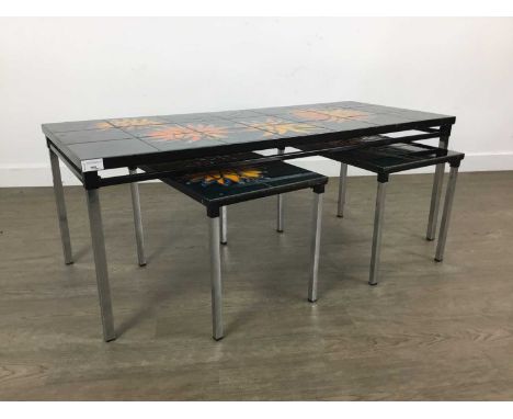 NEST OF THREE MID CENTURY STYLE TILE TOP TABLES, on detachable chrome supportsthe largest 107cm wideThe tiles have several sc