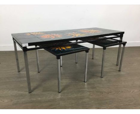 NEST OF THREE MID CENTURY STYLE TILE TOP TABLES, on detachable chrome supportsthe largest 107cm wideThe tiles have several sc