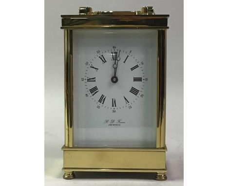 REPRODUCTION CARRIAGE CLOCK, RETAILED BY R. D. FINNE OF ABERDEEN contained in a brass and bevelled glass case14cm high