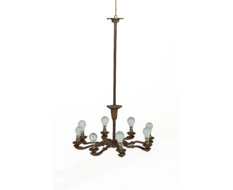 A CAST OXIDISED BRASS EIGHT LIGHT ELECTROLIER with elongated bar and circular stem having eight flat branches. 93cm 