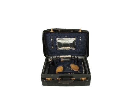 AN EDWARDIAN NAVY BLUE LEATHER CASE with fitted interior having silver mounted dressing set comprising a rectangular tray, si