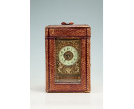 AN EDWARDIAN BRASS CASED CARRIAGE CLOCK, of architectural form, with enamel dial inscribed Reid & Sons, decorated with gilded