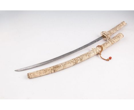 A JAPANESE CARVED ANTLER KATANA SWORD, Meiji Period (1868-1912) of curved outline, the sectional handle with dragon head term