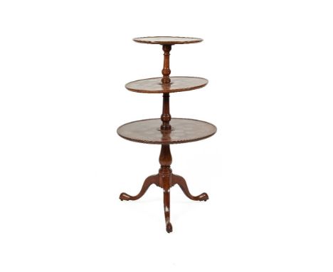 A GEORGE III STYLE MAHOGANY CIRCULAR GRADUATED THREE TIER DUMB WAITER on tripod supports, with pad feet. 125cm high 