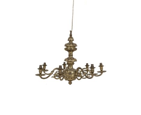 A LARGE CONTINENTAL STYLE BRASS SEVEN LIGHT ELECTROLIER, the baluster stem having scroll arms and plain circular sconces. 68c