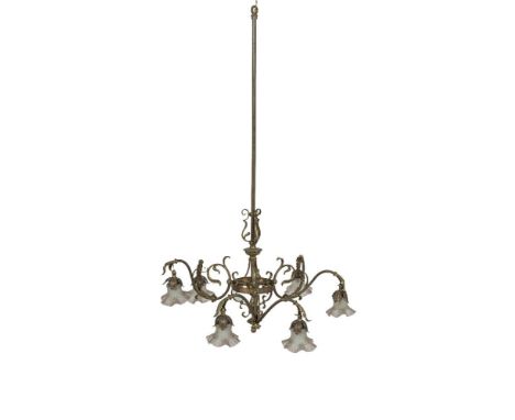 AN EDWARDIAN BRASS SIX LIGHT ELECTROLIER, the elongated bar supporting a circular ring stem with three scroll arms, each supo
