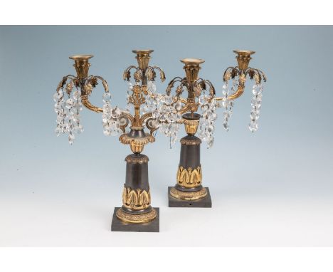 A PAIR OF REGENCY GILT BRASS AND TÔLE TWO LIGHT CANDELABRA the twin scroll branches supported on a circular tapering column w