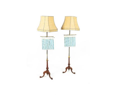 A PAIR OF GEORGE IV MAHOGANY AND BRASS POLE SCREENS/STANDARD LAMPS AND SHADES, raised on scroll tripod supports Provenance: D