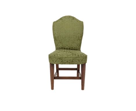 A STAINED WOOD FRAMED UPHOLSTERED ARCH BACK SIDE CHAIR in the Georgian taste, covered in green figured damask and raised on s