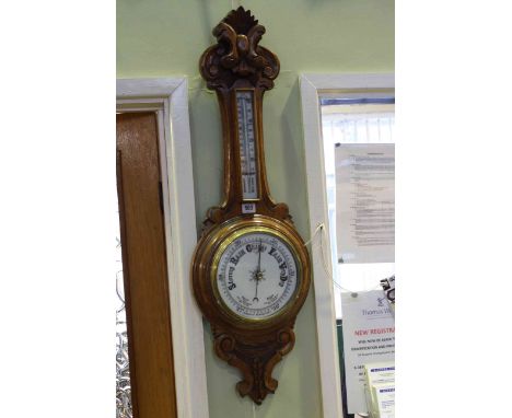 Carved oak aneroid barometer thermometer
