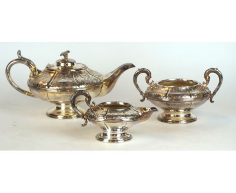 An early 20th Century silver-plated three piece tea service
Comprising tea pot of bulbous form, twin handled sugar bowl, milk